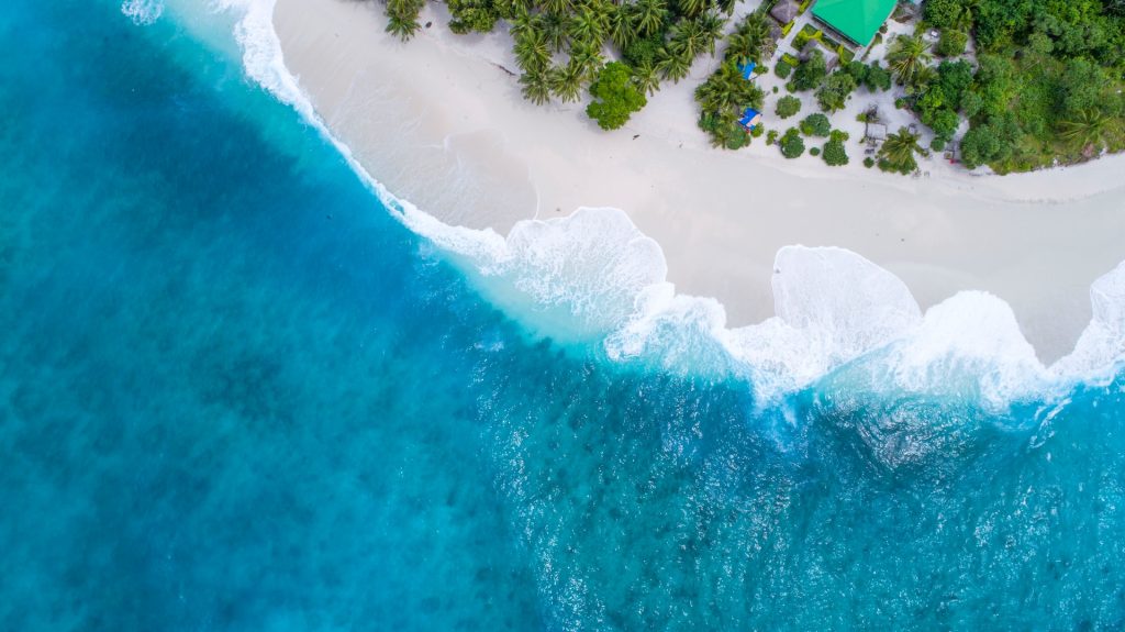 An aerial view of a tropical island in the ocean.
